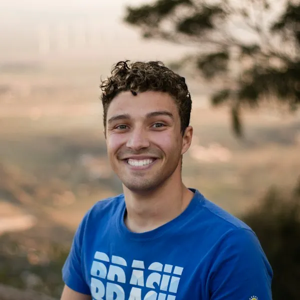 Smiling man outdoors wearing a blue shirt