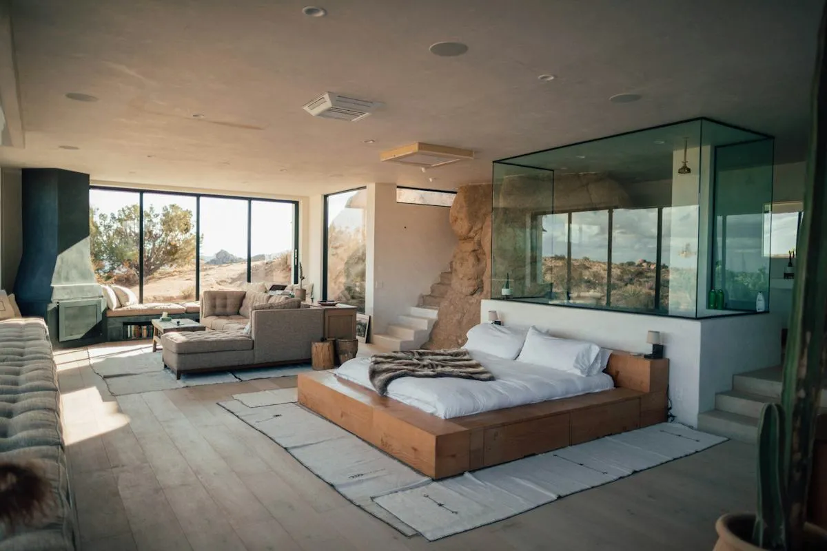Contemporary open-plan bedroom and lounge with large windows