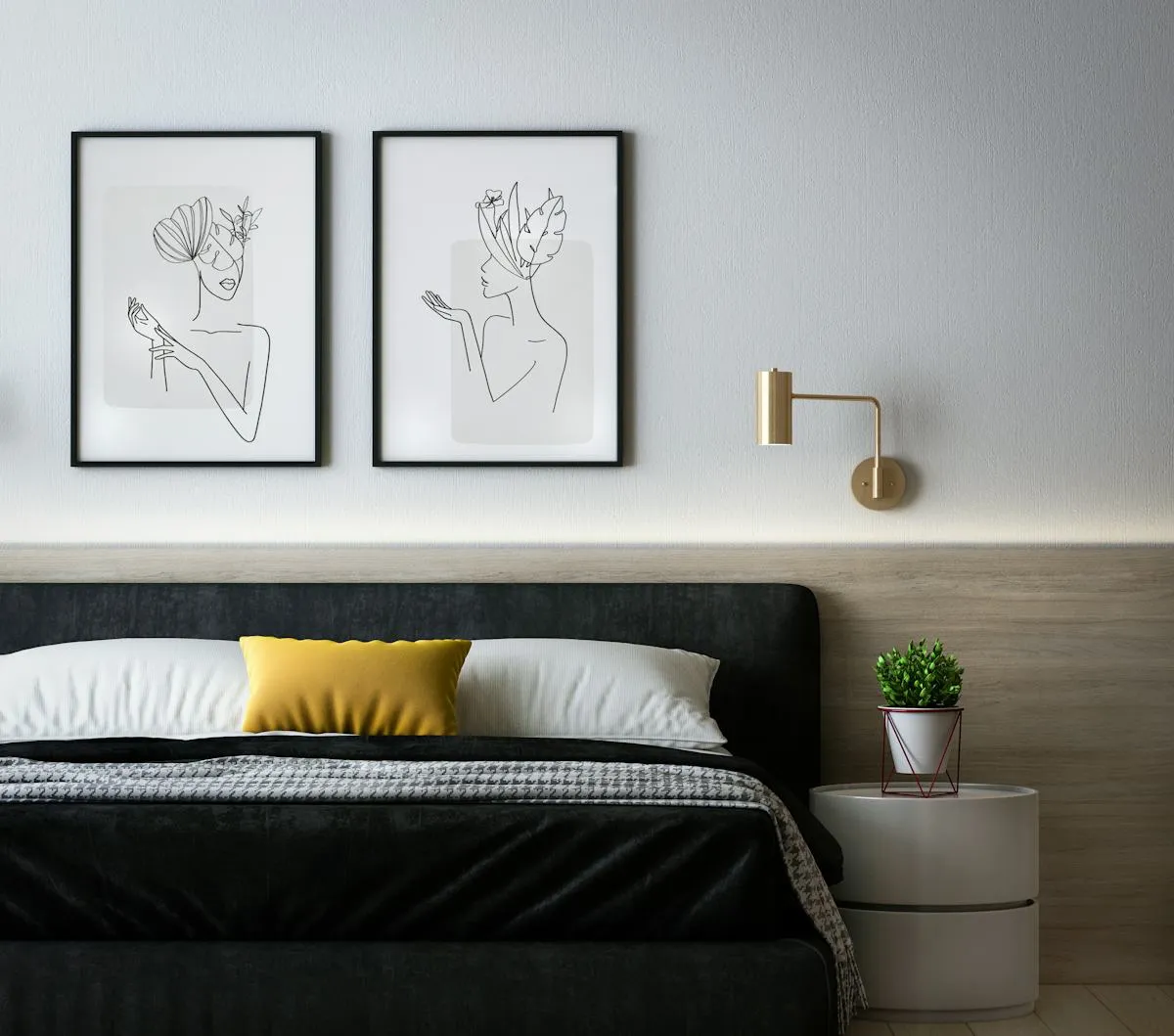 Soft bedroom palette with dark upholstered bed and framed prints