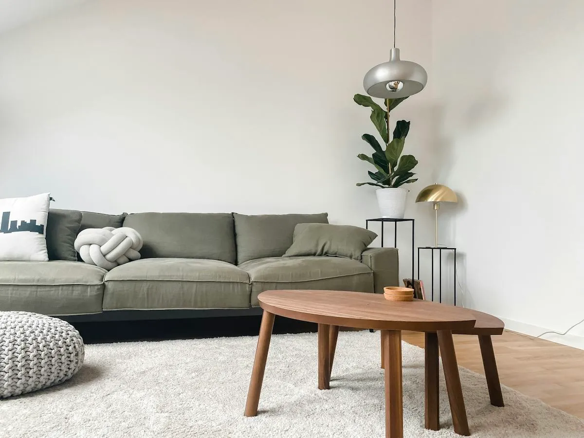 Calm living room with a neutral sofa, timber coffee table and pendant light