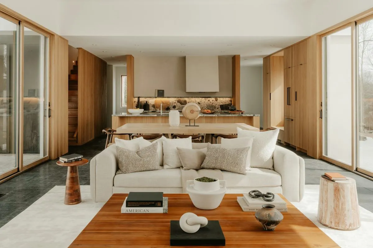 Minimalist open-plan living room with warm timber cabinetry